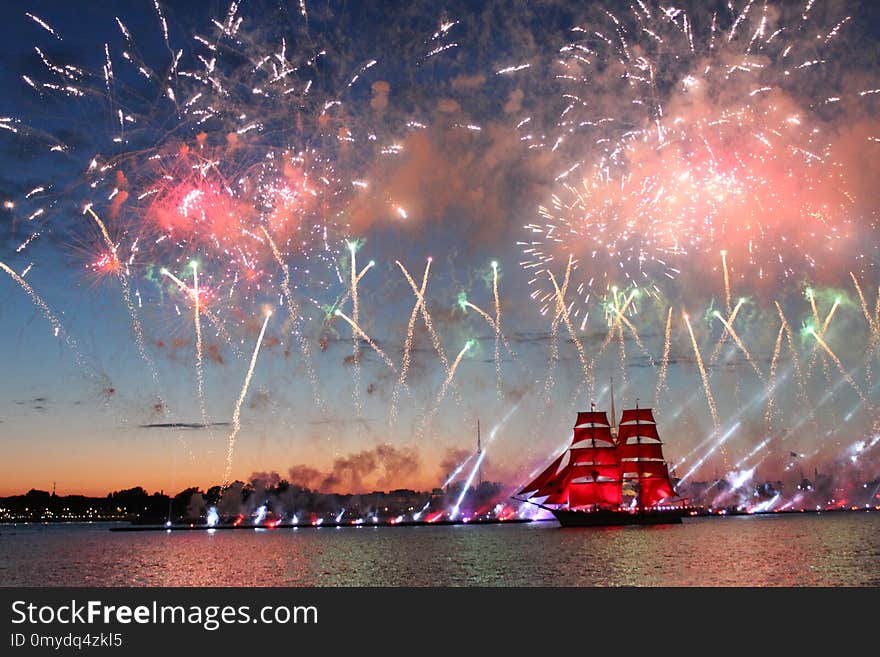 A ship with red sails, and fireworks, in the Neva water area on the day of the celebration of the graduates Scarlet-Sails