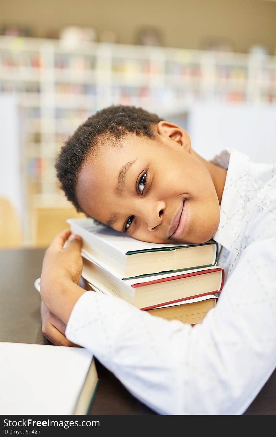 Student is leaning on his books