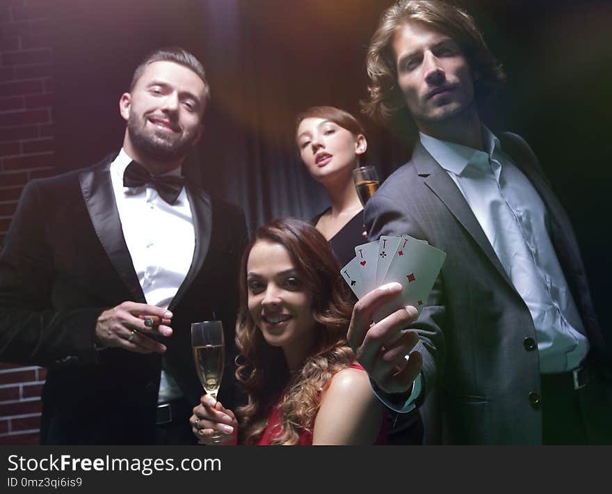 Four People Toasting With Champagne At Roulette In Casino