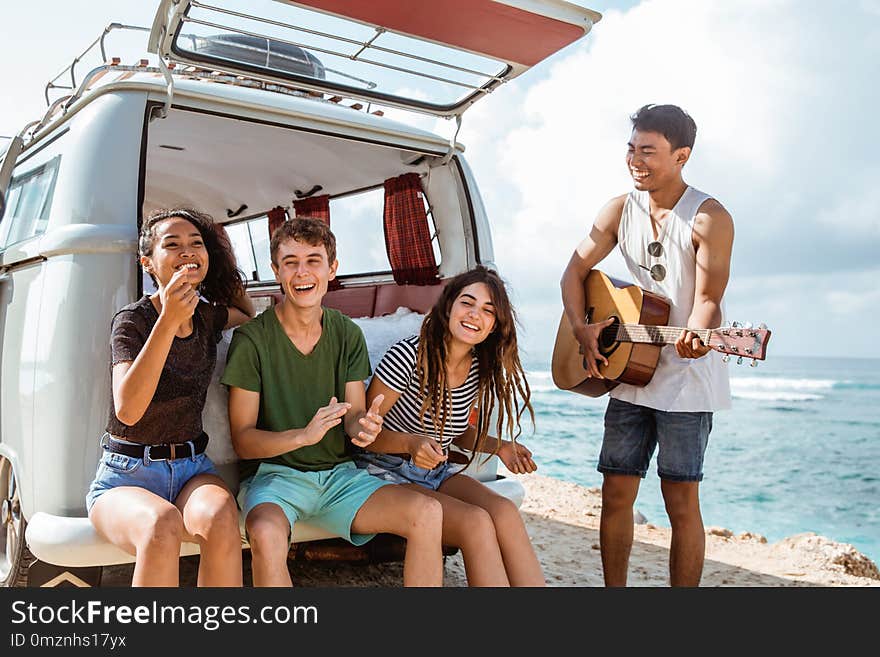 Hipster friends enjoying time at the beach on a summer holiday