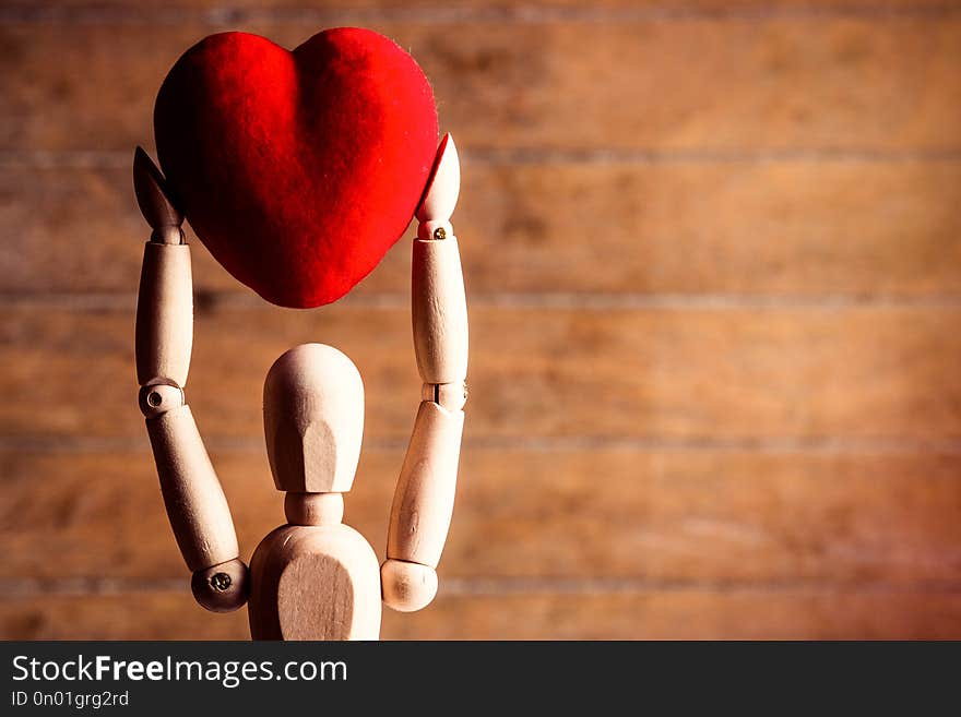 Photo of the beautiful gestalta with heart-shaped toy on the brown wooden background