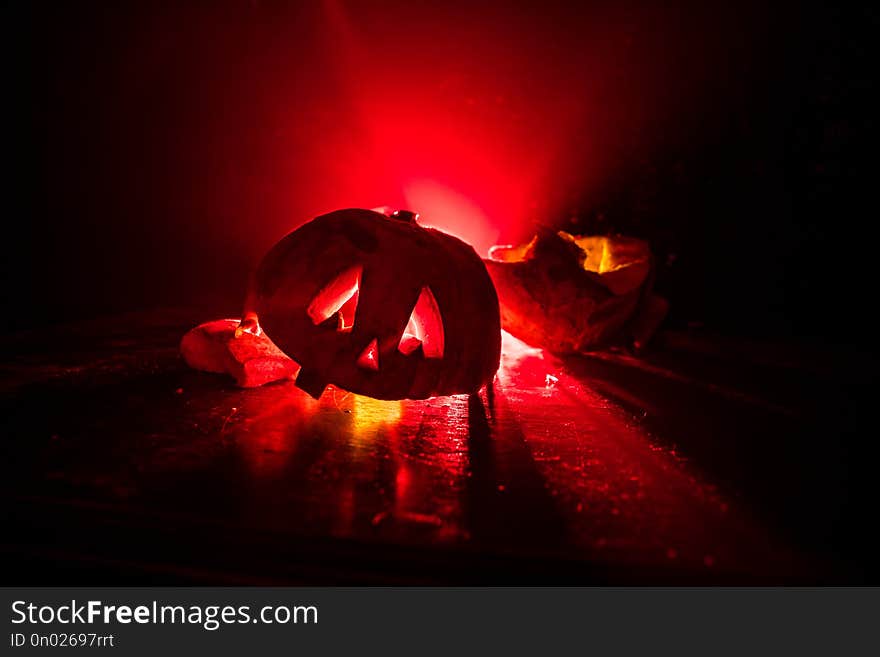 Horror Halloween Concept. Close Up View Of Scary Dead Halloween Pumpkin Glowing At Dark Background.