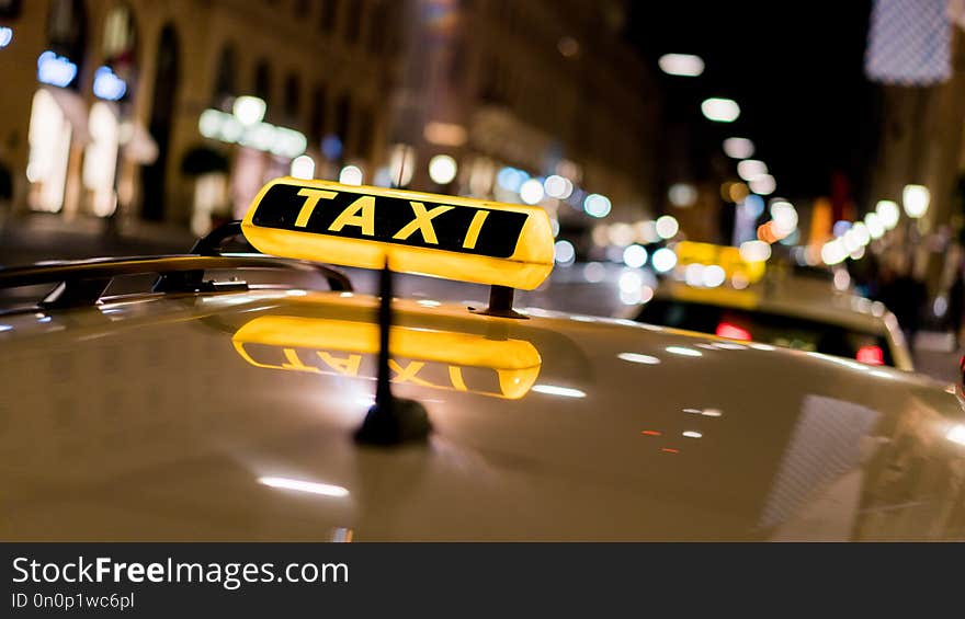 A sign on the roof of a taxi. A sign on the roof of a taxi