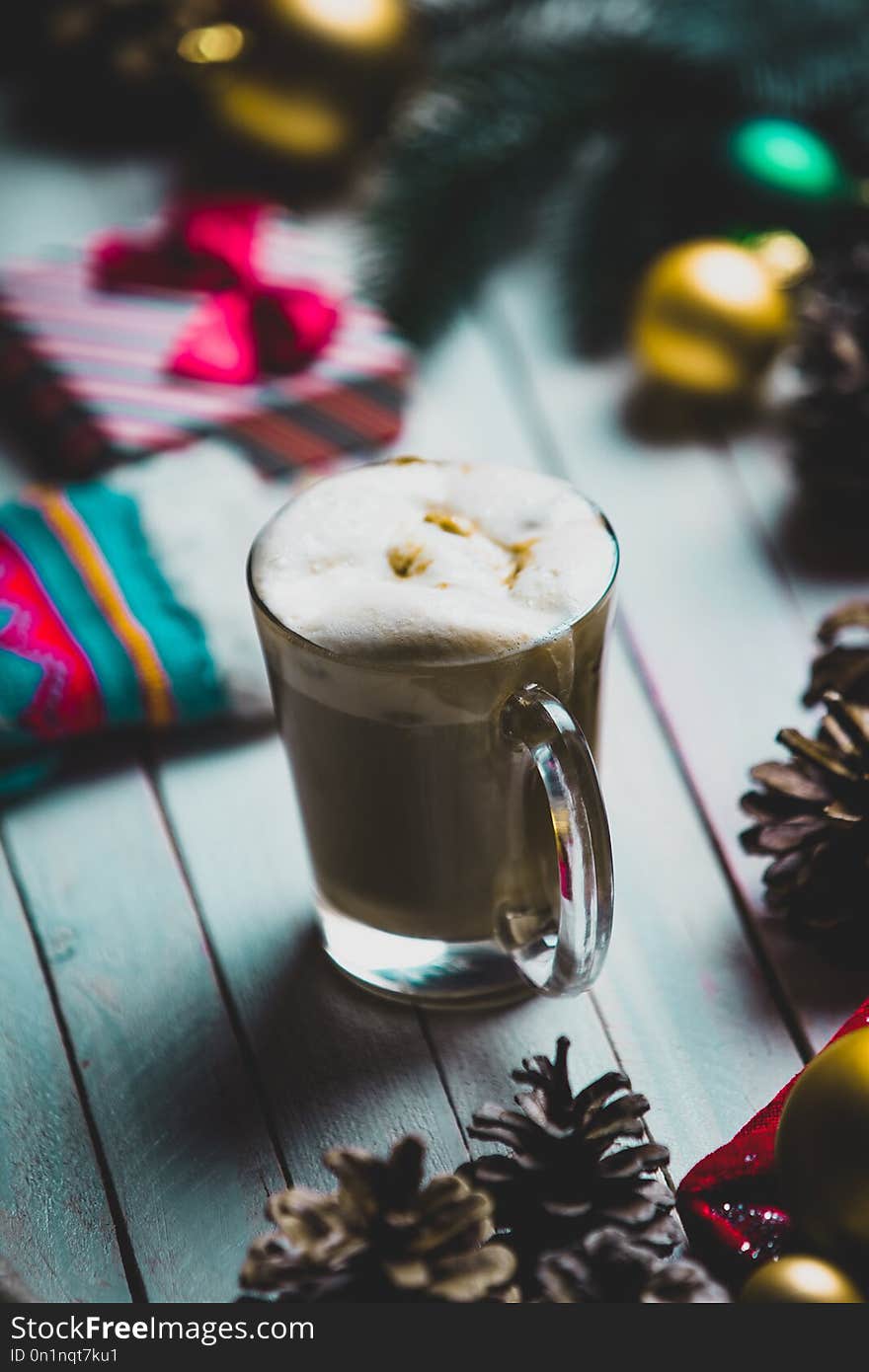 Photo of the beautiful Christmas decorations, gift, sock and cup of coffee on the white wooden background