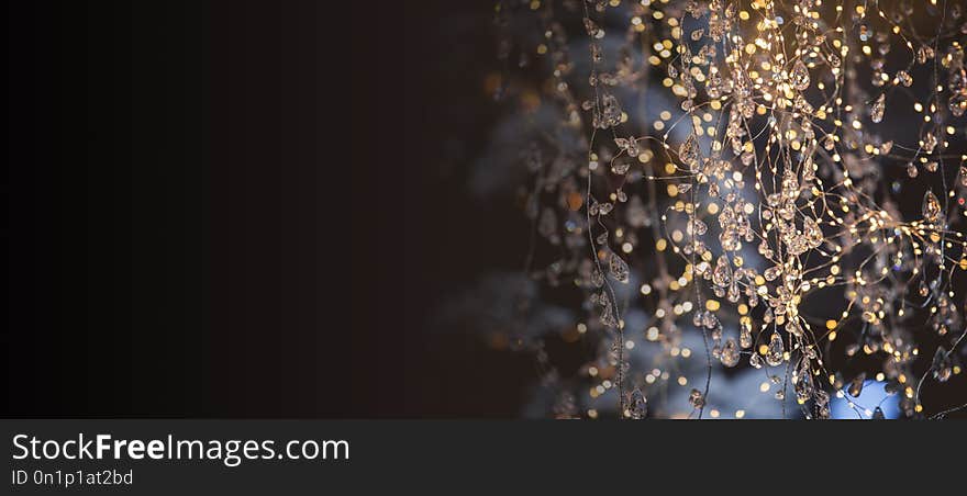 New Year`s abstract garland background. Bokeh from holiday garlands, black background.