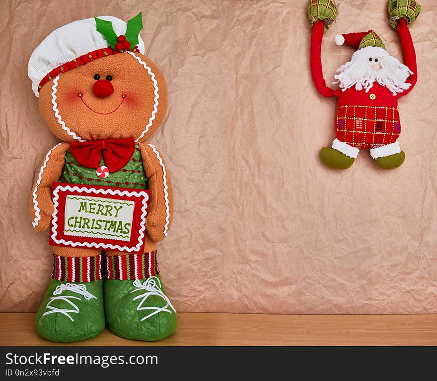 Christmas decoration over a kraft paper background, gingerbread and santa, text space