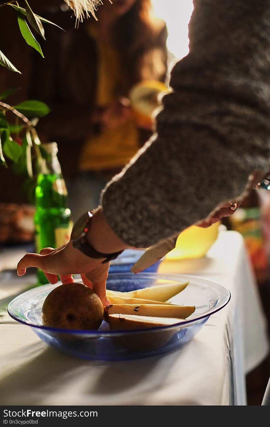 woman cooking with pear at home kitchen party