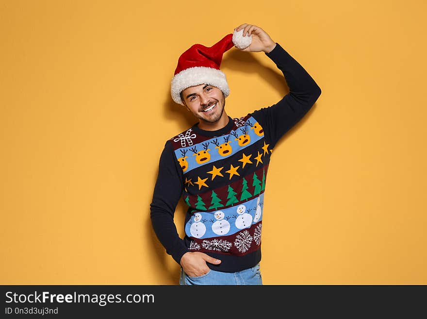 Young man in Christmas sweater and hat