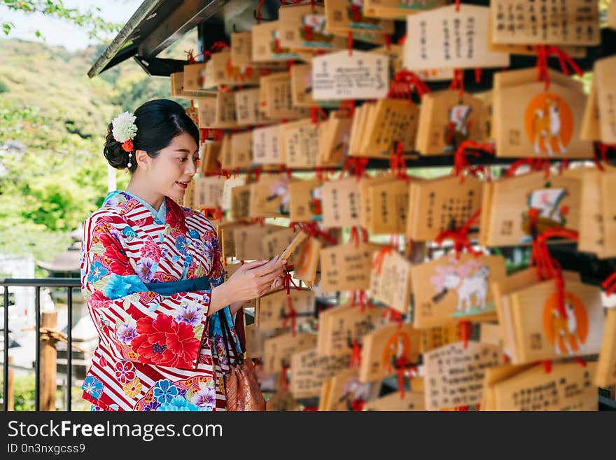 Japanese lady looking at the wooden board