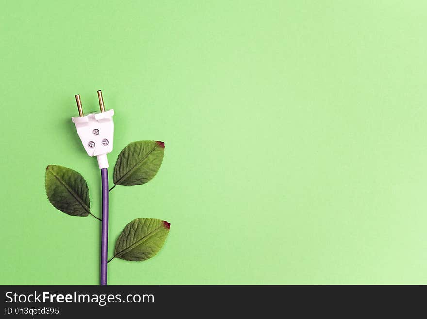 Electrical plug with leaves like a plant. Eco, bio, energy saving concep.