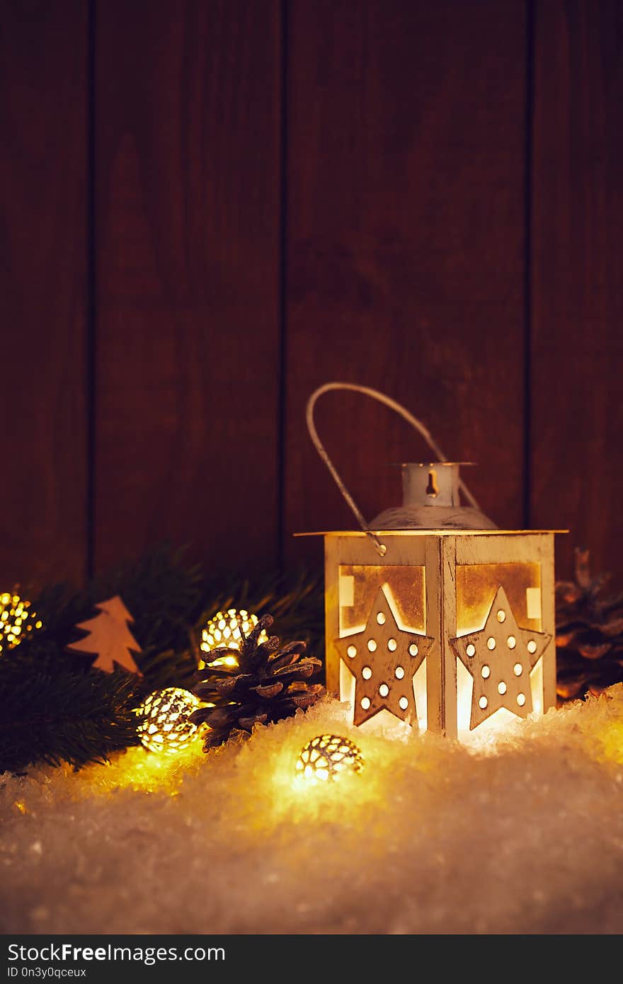 Christmas lantern with shining baubles and pine cones