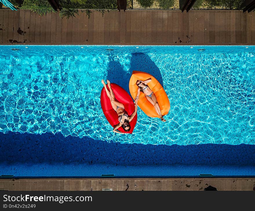 Two girls are swimming in the pool