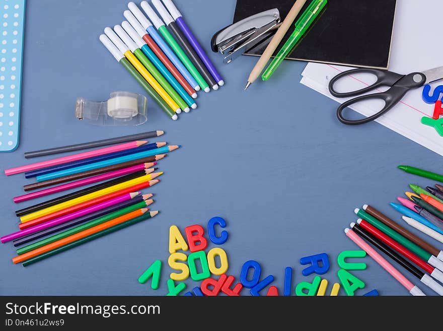 Back to school concept on a blue wooden background