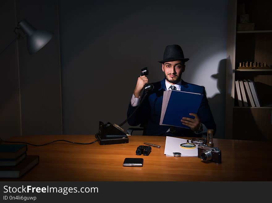 The detective sitting in dark room in vintage concept