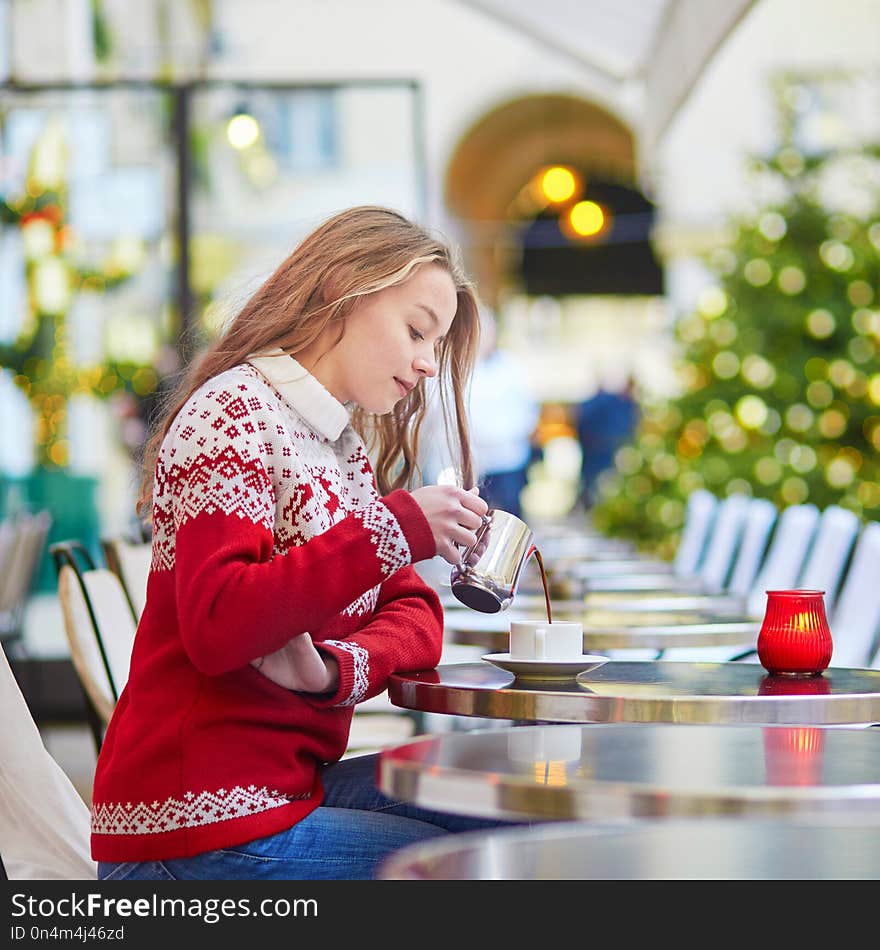 Woman Drinking Hot Chocolate In A Cozy Outdoor Parisian Cafe