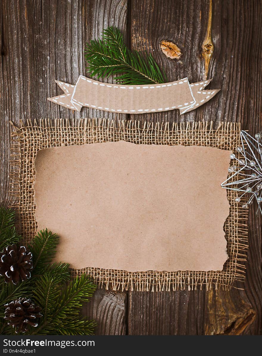 Christmas letter, list, congratulations on a wooden background. free space, mockup new Year. Spruce branches and decoration with their own hands. Cheap greetings