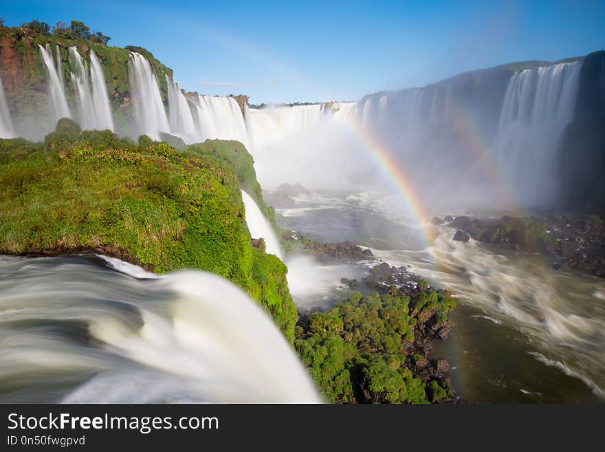 National Park of Iguazu Falls with a full rainbow over the water, Foz do Iguazu, Brazil. National Park of Iguazu Falls with a full rainbow over the water, Foz do Iguazu, Brazil