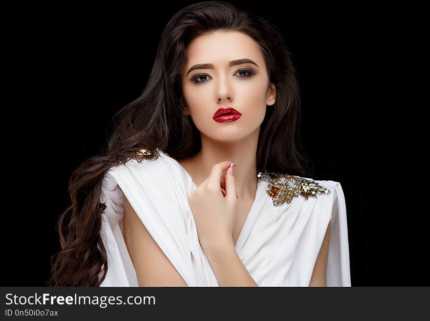 Brunette asian girl with long curly hair. Studio shot