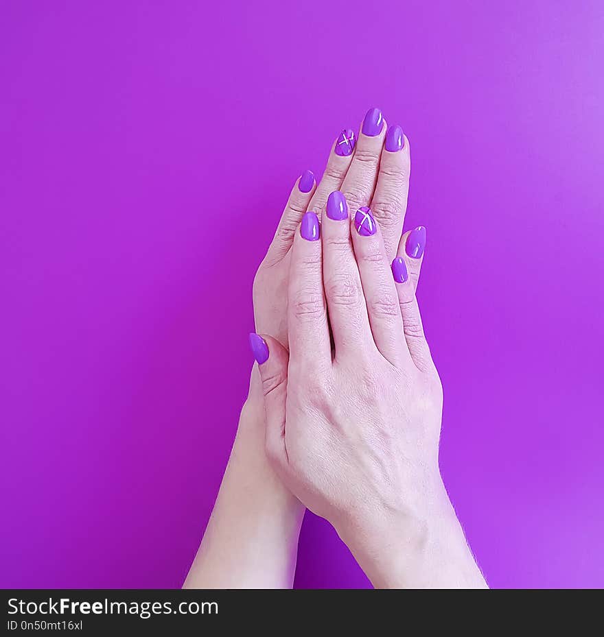 Hands violet manicure on colored paper minimal glamour design fashionable polish trendy beauty. Hands violet manicure on colored paper minimal glamour design fashionable polish trendy beauty