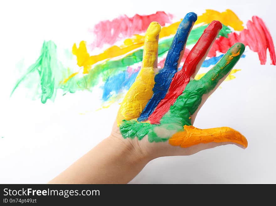 Child with painted palm on color background