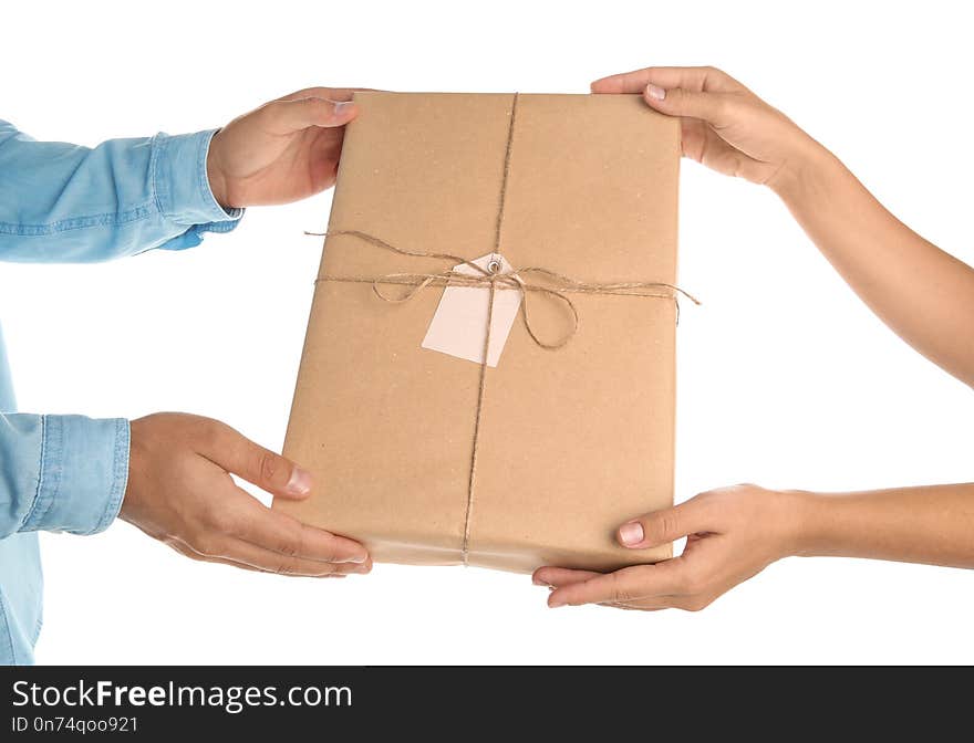 Woman receiving parcel from courier on white background, closeup