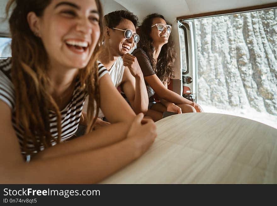 Carefree hipster having fun inside retro van on trip summer holiday at the beach