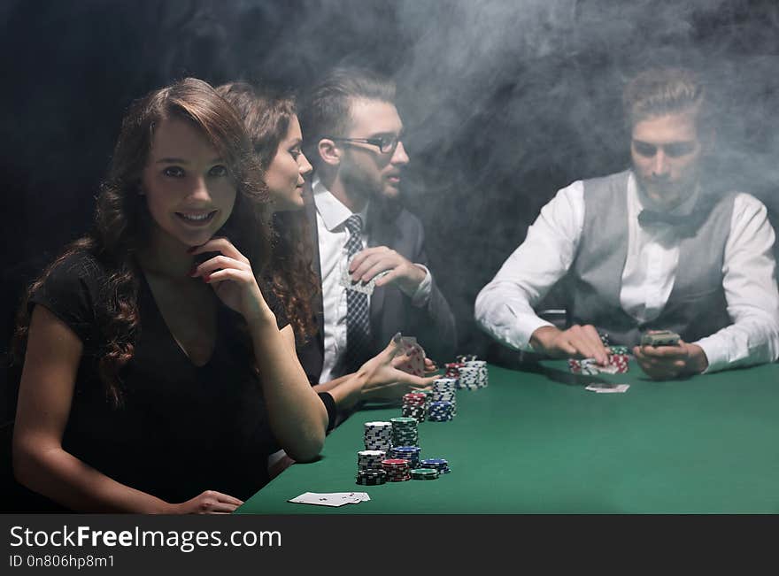 Modern business woman sitting at craps table in a casino.