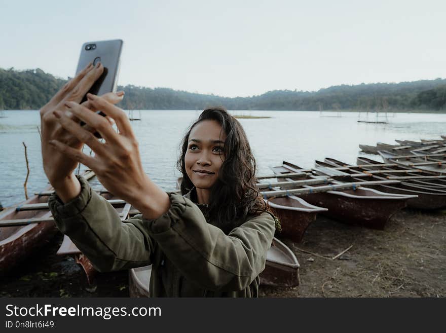 Attractive young woman taking selfie of her self while enjoying nature. Attractive young woman taking selfie of her self while enjoying nature