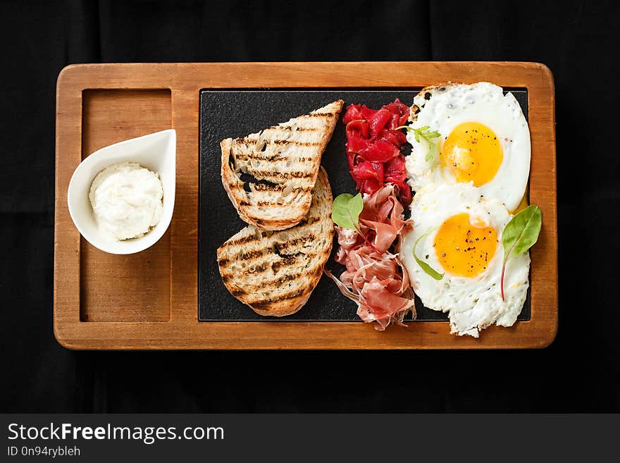 Top view breakfast eggs and toast jamon and cheese. American breakfast concept. Food on wooden board. Delicious lunch. Serving dishes concept. Restaurant food concept, healthy food.