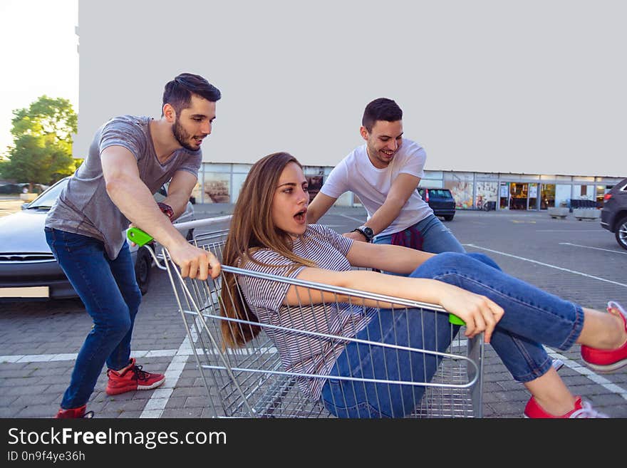 Group Of Friends Having Fun With Shopping Trolley