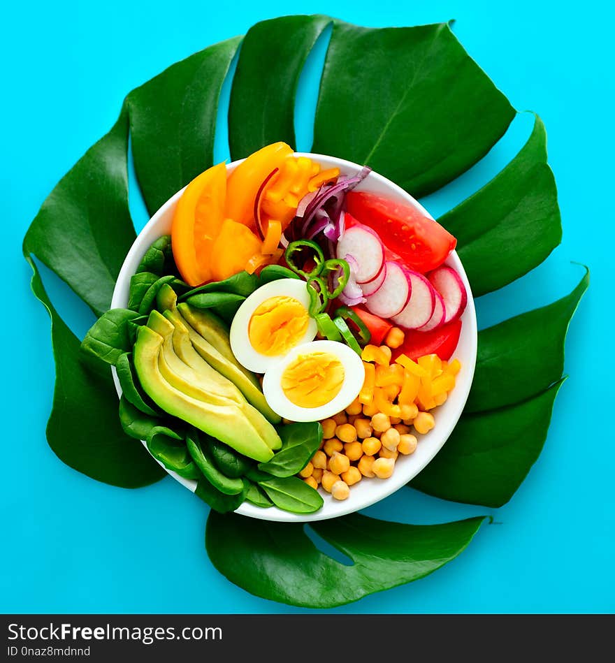 Freshly cooked Buddha bowl salad served on summer style decorated table, view from above, blank space for a text