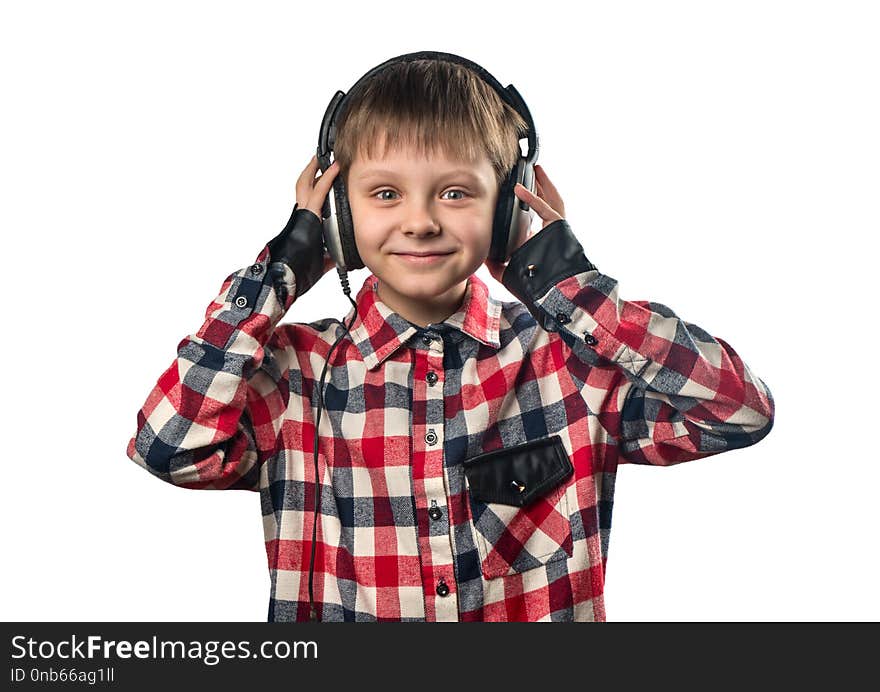 Portrait of a little boy listening to music in headphones on a white background