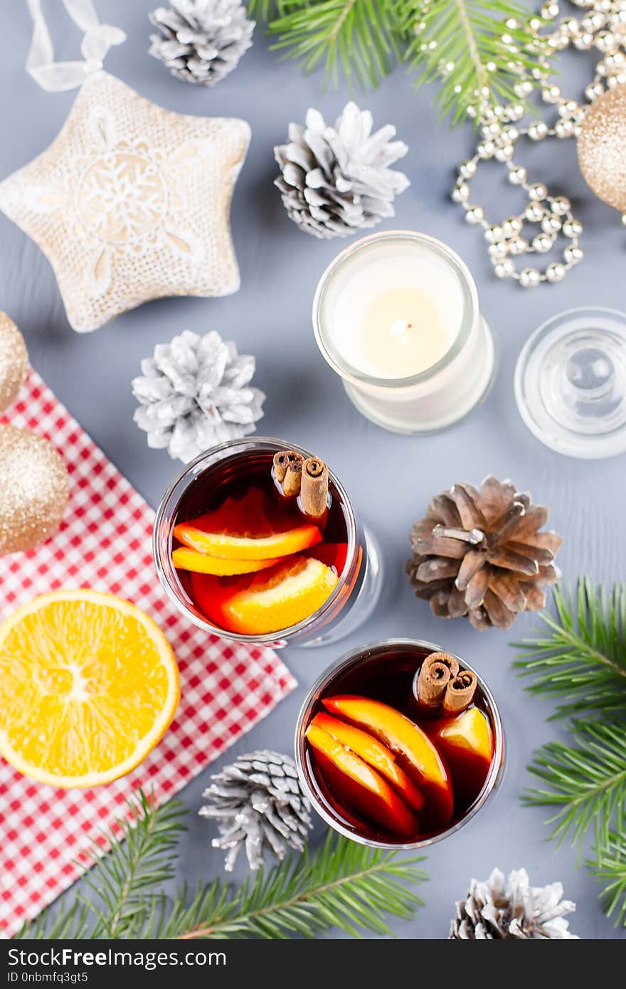 Two glasses of hot mulled wine with spices and sliced orange. Christmas drink with decorations. Top view