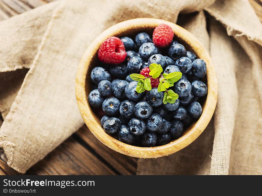 Fresh blueberries on the wooden table, selective focus