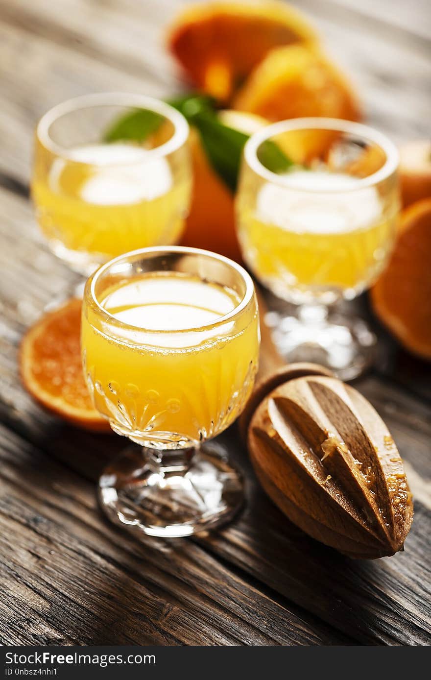 Homemade mandarin juice on the wooden table, selective focus