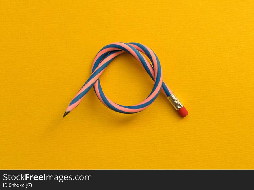 Flexible pencil . Isolated on light background. Bending pencil