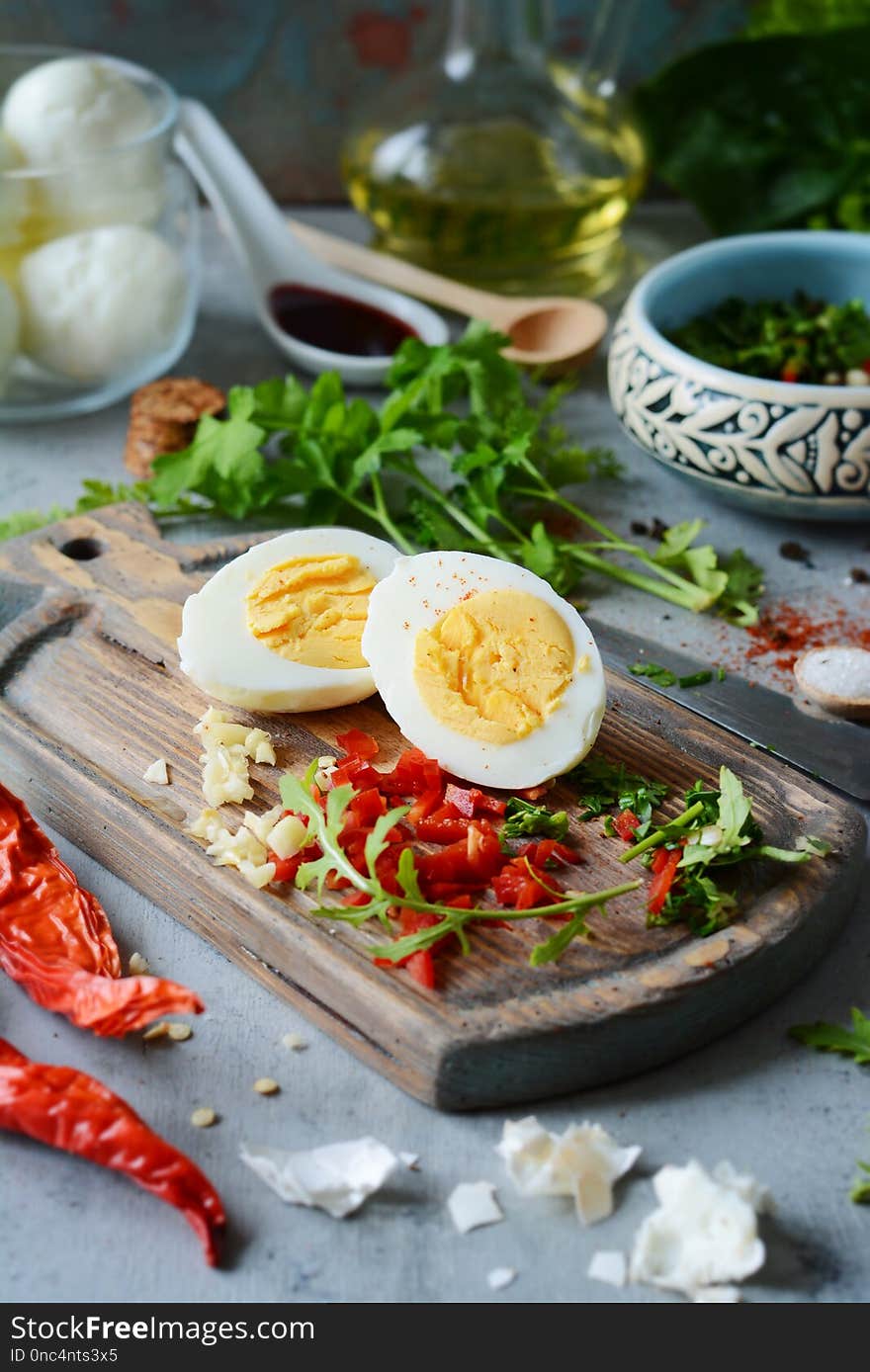 The process of cooking boiled marinated chicken eggs with vegetables, herbs, spices and tomato sauce.