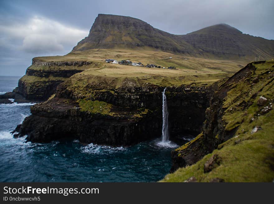 Waterfall and Gasadalur village, Faroe Islands.