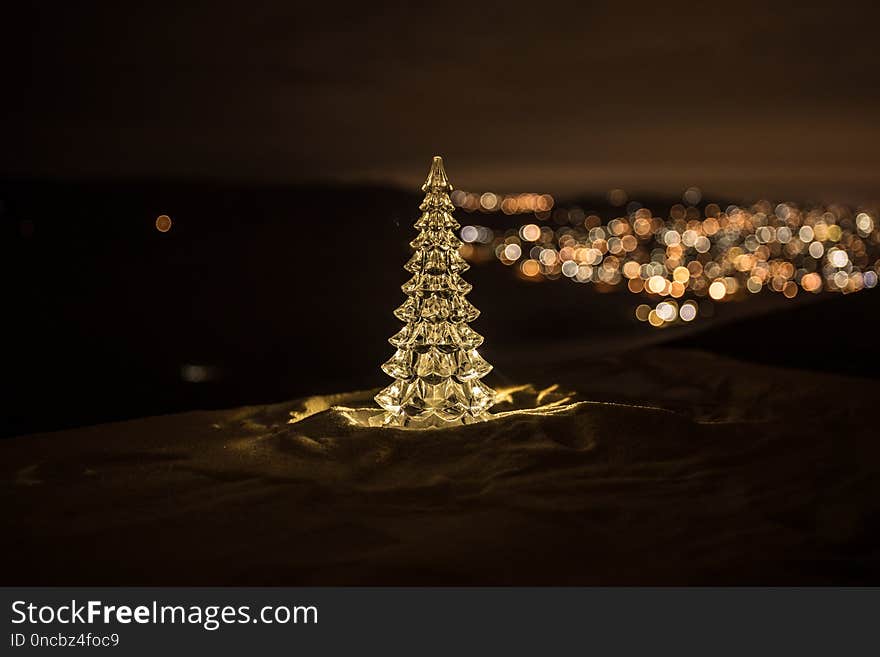 Christmas decorations. Fir tree standing on snow with beautiful holiday decorated background and traditional holiday attributes. Selective focus. Empty space for your text