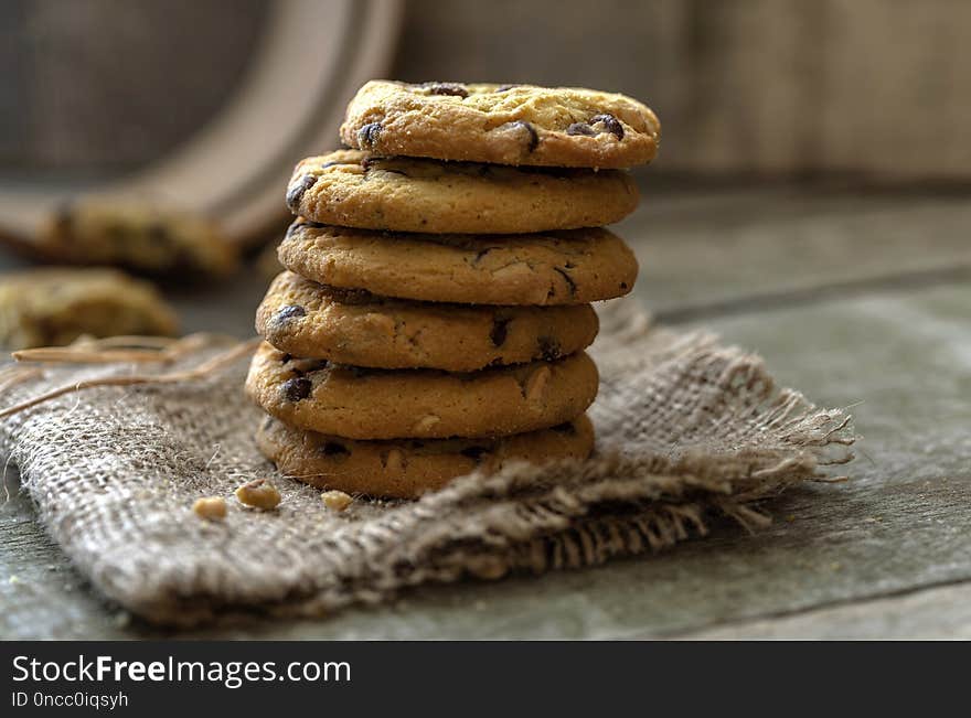 Stacked rounded chocolate cookies on natural wooden desk