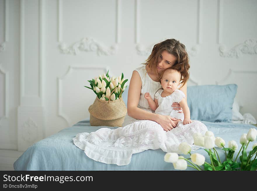 beautiful young mother with baby girl in her arms. The concept of a happy family, motherhood. mother playing with her baby in the