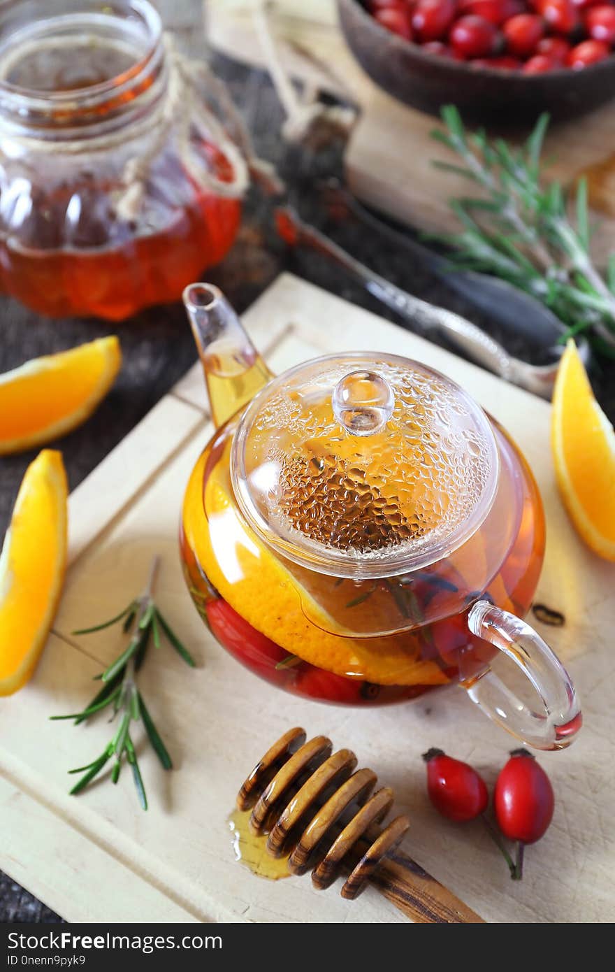 Healthy winter beverage. Rose hip tea with oranges, rosemary and