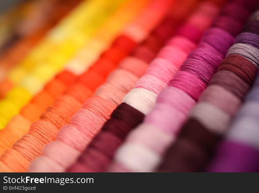 Multicolor sewing threads background. Shallow depth of field