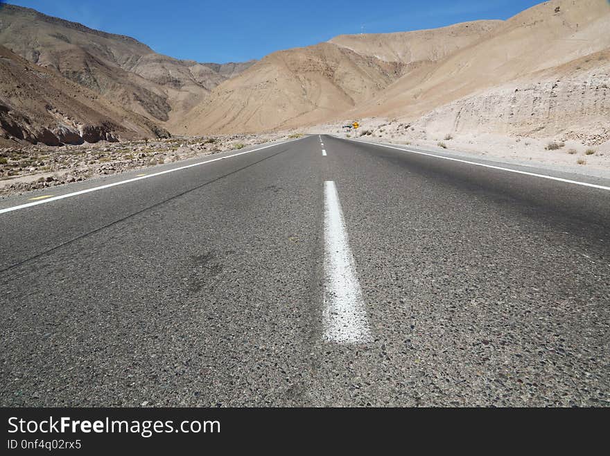 Empty and straight road in a totally arid environment of chilean Atacama desert. Empty and straight road in a totally arid environment of chilean Atacama desert