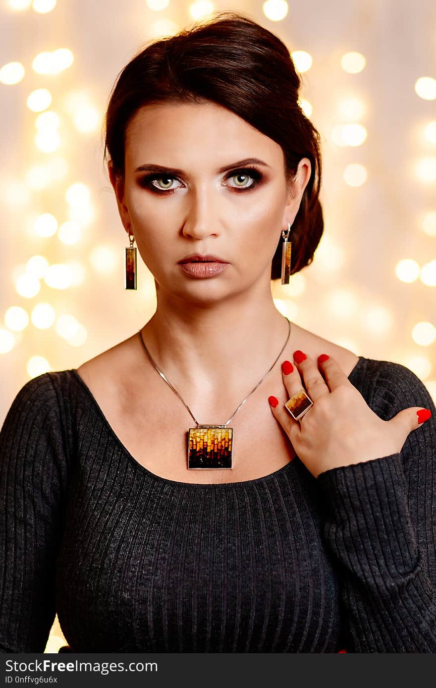 Young attractive woman posing with jewelry necklace. Woman at Christmas. Christmas surprise