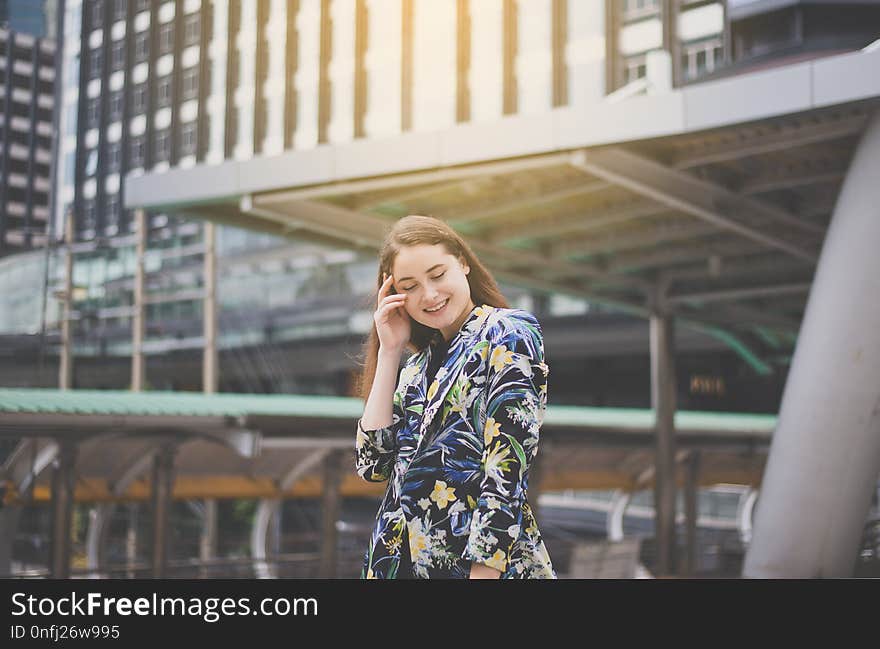 Portrait beautiful female with positive attitude expressing energy in good time,Woman walking in the city,Happy and smiling