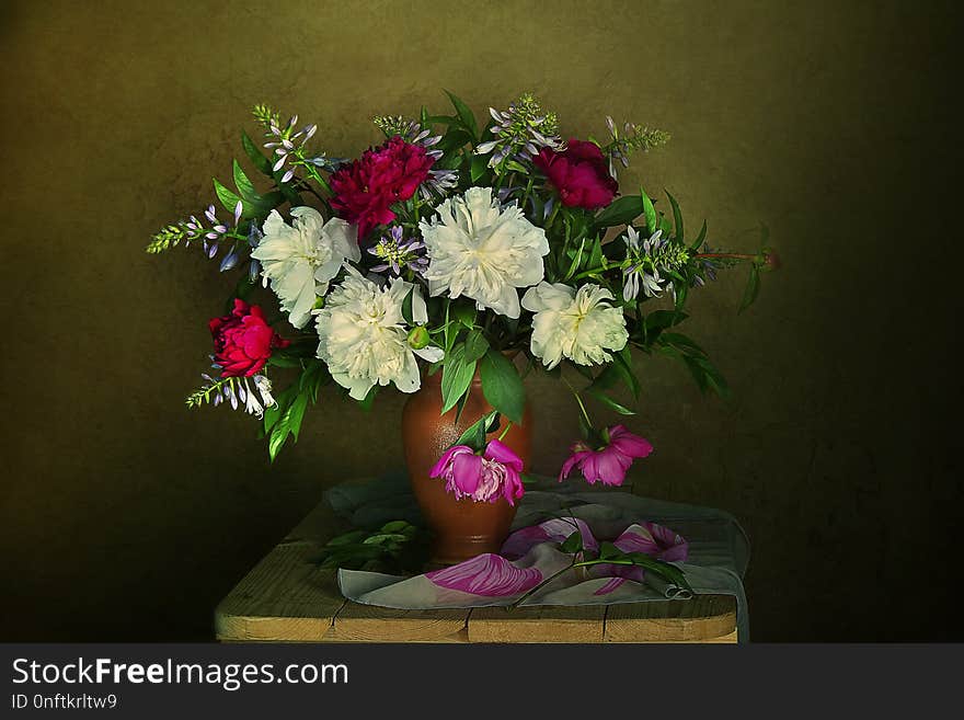 Bouquet of pink and white peonies in a vase on the table