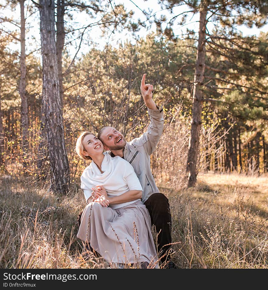 Couple in love hugging in the forest.