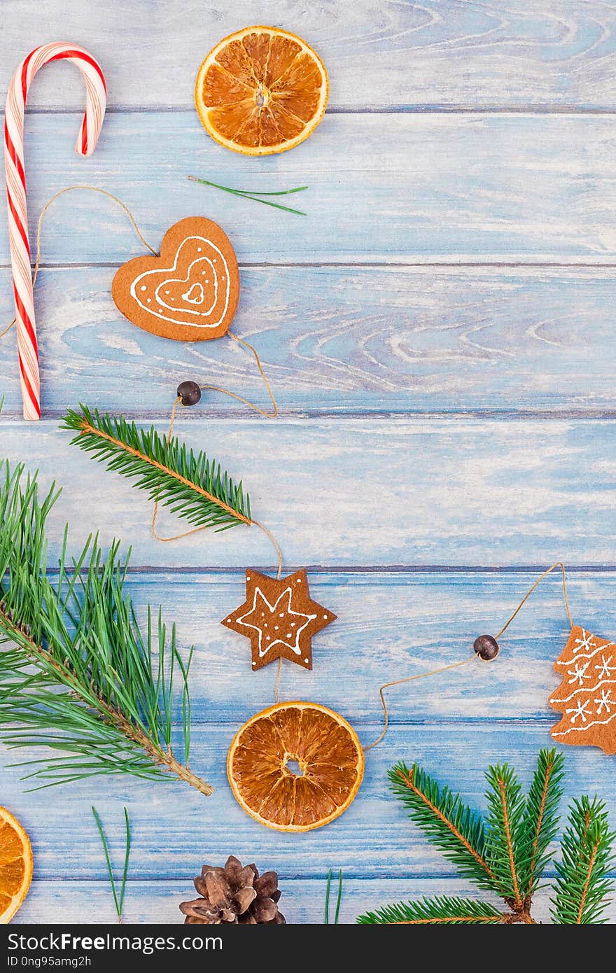 New Year Christmas pattern flat lay top view Xmas holiday handmade handicraft texture with fir tree pine branches cones dried oranges blue wooden background copy space Template for greeting card. New Year Christmas pattern flat lay top view Xmas holiday handmade handicraft texture with fir tree pine branches cones dried oranges blue wooden background copy space Template for greeting card