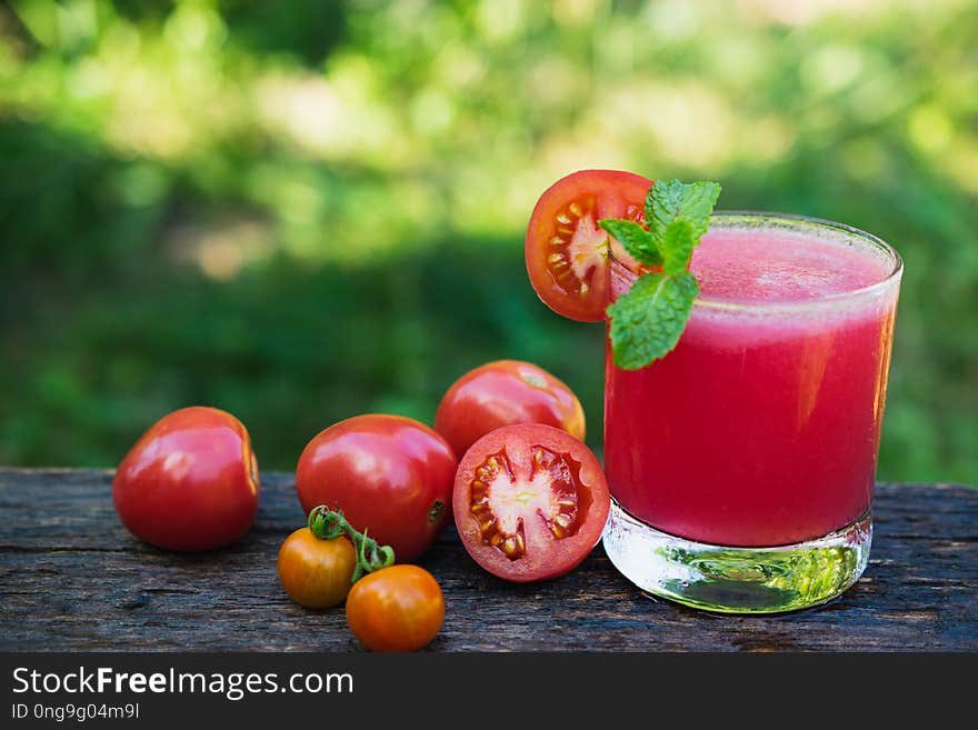 Tomato Juice On Wooden With Tomato Be Side And Mint Leaves On To